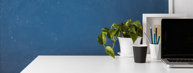 Wall Mural - Home office desk with blue wall and white table mock up.	
