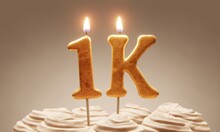 Milestone Cake Celebrating 1000 Followers Or Subscribers. Golden ‘1k’ Number Candles On Cake With Icing In Neutral Tones. 3D Rendering