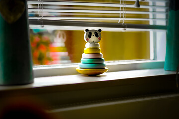 Poster - A closeup of the cute pyramid toy on the windowsill.