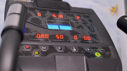 Electronic Indicators of Data on the Monitor a New Modern Elliptical Trainer. Choosing a program for training on a cross-trainer. Indicators of distance, speed, calorie consumption, time, heart rate.