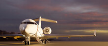 A Luxury Private Jet Parked On Runway Over Blurred Sunset Sky View