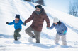 © lalalululala - Asian father and his children holding hands and walking in the snow together