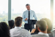 © Nola V/peopleimages.com - Delivering an expert speech. Cropped shot of a handsome mature businessman speaking at a business conference.