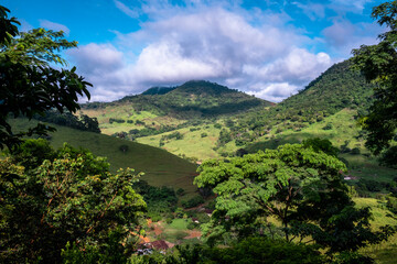 Beautiful valley under a mountain. Cloudy sky and fog. Green valley in a jungle. brazil jungle country scenery.