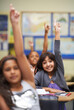 © Mapodile M./peopleimages.com - They all know the answer. A group of students raising their hands in class.