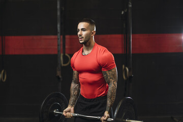 Sticker - Strong muscular European guy with cool tattoos working out in a gym