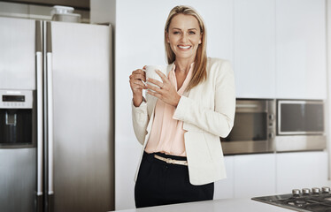 Poster - Got to keep on the go. Portrait of a cheerful middle aged businesswoman standing behind a counter while drinking a cup of coffee inside of a kitchen during the day.