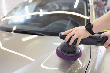 Wall Mural - Male hands are polishing the hood of a vehicle