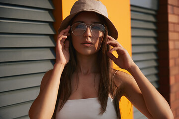 Wall Mural - Stylish woman in bucket hat in street