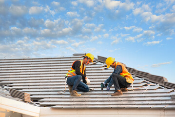 roof extension roof installation engineer roof-construction workers stand on tiled roof