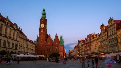 Wall Mural - Wroclaw, Poland. View of the market square in Wroclaw, Poland during the sunset. Time-lapse of Wroclaw town hall from day to night, zoom in