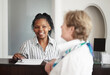 © Thomas Talkner/peopleimages.com - Diligent, friendly assistance. A receptionist giving a senior woman the keys to her hotel room.