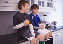 Boys Will Be Boys. Cropped Shot Of Two Young Boys Having Cold Drinks After Soccer Practice.