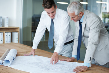 Wall Mural - Ensuring the blueprints are perfect. Two corporate architects going over the plans of a building together.