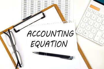 Poster - Text ACCOUNTING EQUATION on the white paper on clipboard with chart and calculator