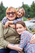 © DariaTrofimova - Portrait of   elderly woman with grandchildren  on   spring day in   park.