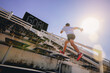 © Panumas - Young man running sprinting up stairs at stadium with GOAL text in scoreboard. Fit runner fitness runner during outdoor workout. Selected focus