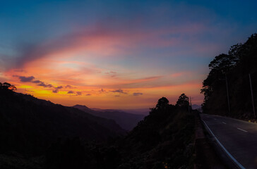 Wall Mural - Empty highway road on the hillside with breathtaking sunset background in Benguet, Philippines