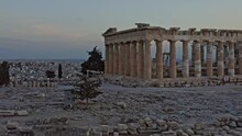 Athens Greece Aerial V32 Low Level Fly Around Close Up Shot Of Ancient Ruins Of Greek Parthenon Located In City Of Athens With Majestic Golden Sunset And Cityscape In The Background - September 2021