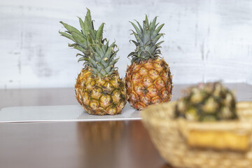 Wall Mural - Closeup shot of fresh pineapples on the wooden table