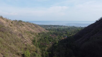 Sticker - Aerial view of a small town surrounded by greenery-covered hills in Bali, Indonesia