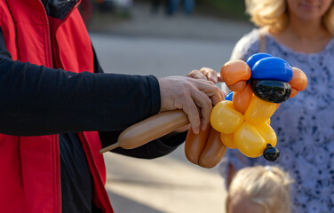 Wall Mural - man making funny balloon dog figure for children