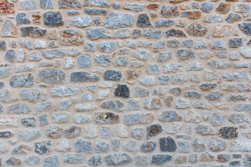 Wall Mural - Stone wall texture background. Old stonewall traditional pattern building facade, natural material