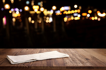 Wall Mural - background Image of wooden table in front of abstract blurred restaurant lights