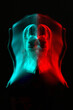 © Rytis - Abstract woman silhouette portrait in bright light trails of light painting in RGB split style of red and blue colors. Long exposure photo. Image contains noise and motion blur