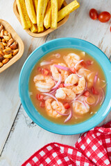 Wall Mural - Ecuadorian shrimp ceviche, a traditional appetizer. On a white wooden table.