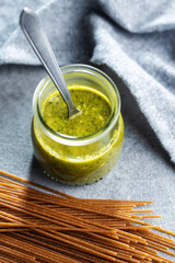 Wall Mural - Fresh green basil pesto in jar.