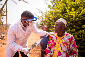 african doctor visits an elderly patient and they converse during the medical examination. health ca