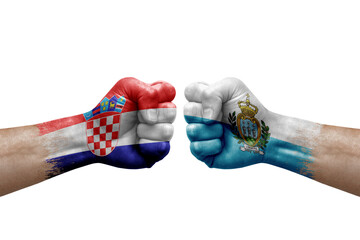 Two hands punch to each others on white background. Country flags painted fists, conflict crisis concept between croatia and san marino