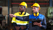 © otello-stpdc - Diversity, colleague of industry heavy team engineer. Professional inspection, technician, worker wearing safety uniform, helmet, hardhat while checking maintenance machine line production factory.