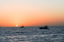 Two Sportfishing Boats Are Catching Live Bait At Sunrise Off The Coast Of Baja Mexico