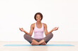 © Kobus T/peopleimages.com - Enjoying a yoga session. A young african-american woman relaxing with a yoga routine.