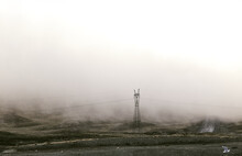 Scenery Of Power Lines In Foggy Mountainous Valley