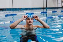 Hispanic Young Man Swimmer Athlete Wearing Cap And Goggles In A Swimming Training At The Pool In Mexico Latin America