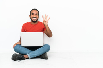 Wall Mural - Young Ecuadorian man with a laptop sitting on the floor isolated on white background happy and counting four with fingers