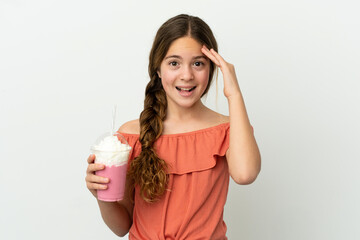 Wall Mural - Little caucasian girl with strawberry milkshake isolated on white background with surprise expression