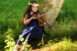 Young girl playing the viola in nature