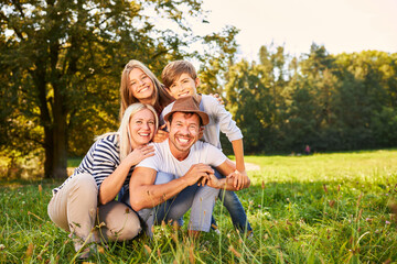 Wall Mural - Happy family with two children in summer