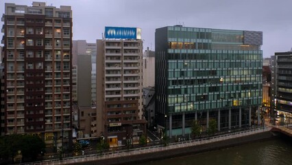 Sticker - Fukuoka, Japan. Aerial view of the hotel buildings in the center of Fukuoka, Japan in the cloudy evening. Time-lapse with car traffic with modern buildings, panning video