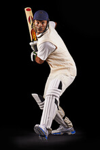 Hes Got Some Talent With The Bat. A Cropped Shot Of An Ethnic Young Man In Cricket Attire Isolated On Black.