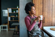 © NDABCREATIVITY - Beautiful young african american woman enjoying a cup of coffee while relaxing