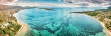 Aerial Panoramic Scenic View Of Azure Blue Lagoon And Paradise Bay With Majestic Patterns On A Sea Shelf. Resort Village Of Vourvourou On Sithonia Peninsula In Halkidiki, Greece