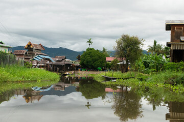 Poster - Floating houses and buildings built on the water or riverbank of Inle Lake, Myanmar, Burma, SE Asia, with high level of water during monsoon season.