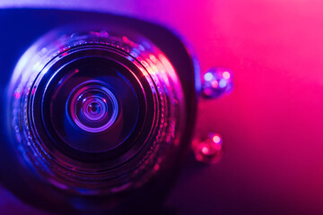 Wall Mural - .Camera lens with purple and pink backlight. Optics