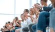 © ASDF - background image of young people applauding in the conference room