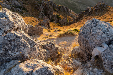 Poster - Rock formation on a mountain with sunlight of sunset on ground in Subbetic Mountains in Spain